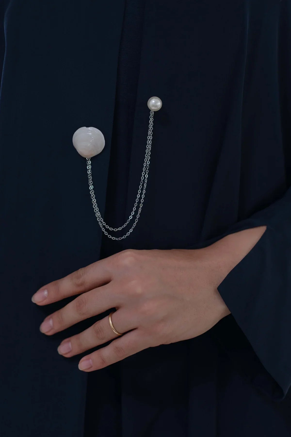 Dana pale shell styled on navy abaya